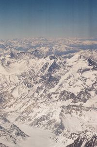 Aerial view of snowcapped mountains against sky