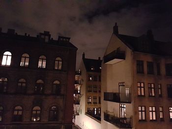 Low angle view of buildings against sky at night