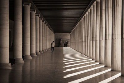 People walking in corridor of building