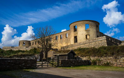 Low angle view of built structure against blue sky