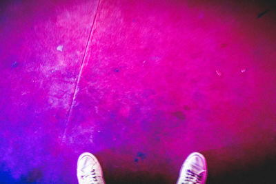 Low section of person standing on tiled floor