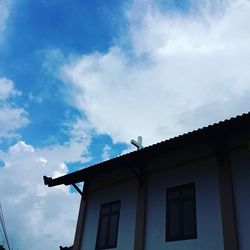 Low angle view of building against cloudy sky
