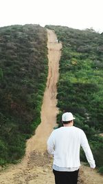 Rear view of man standing on land