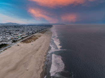 Scenic view of beach against sky during sunset