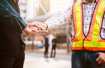 Close-up of people stacking hands 