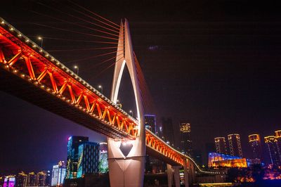 Low angle view of suspension bridge at night