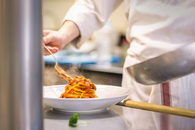 Midsection of person preparing food