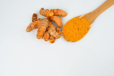 High angle view of orange berries on white background