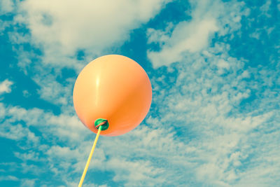 Low angle view of balloons against sky