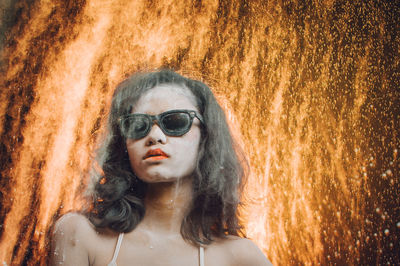 Digital composite image of woman against fire