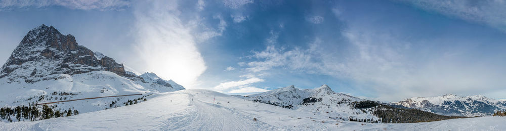 Snow covered landscape against the sky