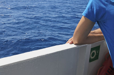 Midsection of man sailing on sea