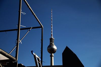 Low angle view of tower against blue sky