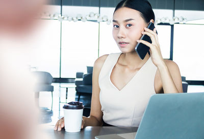 Portrait of young woman using smart phone