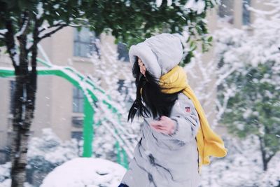 Woman in warm clothing running outdoors during winter