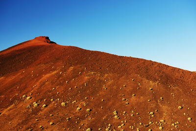 Low angle view of mountain against clear blue sky at teide national park