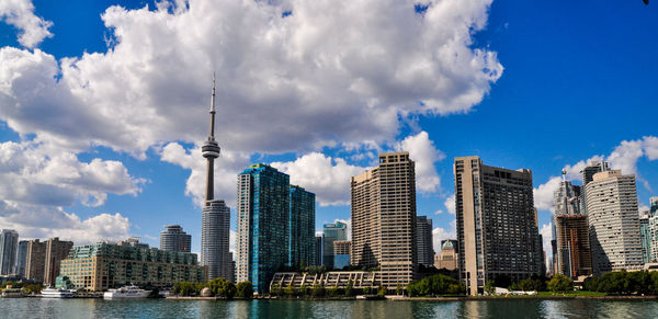 Panoramic view of buildings against cloudy sky