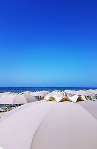 Scenic view of beach against clear blue sky