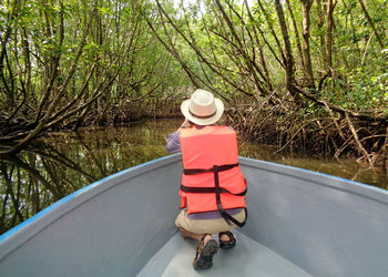 Man on the boat among ban tha ranae mangrove forest in trat province, eastern region of thailand