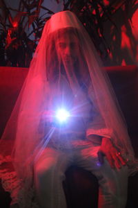 Digital composite image of woman with illuminated lights