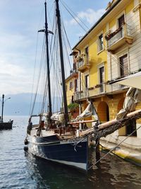 Sailboats moored on sea against sky