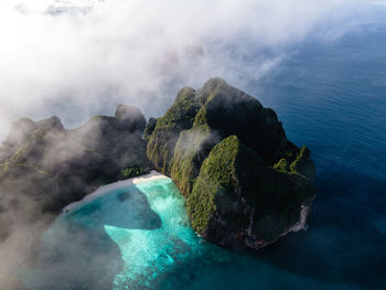 High angle view of rocks by sea against sky