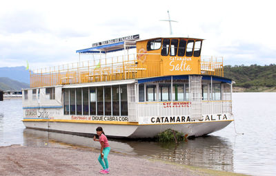 Woman on boat against sky