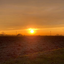 Scenic view of field against sky during sunset