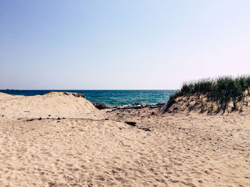 Scenic view of beach against clear sky