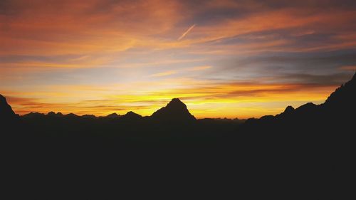 Scenic view of silhouette mountains against sky during sunset