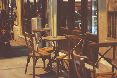 Wooden chairs and table arranged at cafe