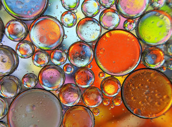 Colorful bubbles abstract background, oil bubbles in transparent liquid backdrop