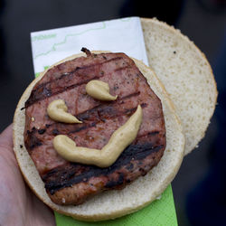 Cropped image of person holding burger