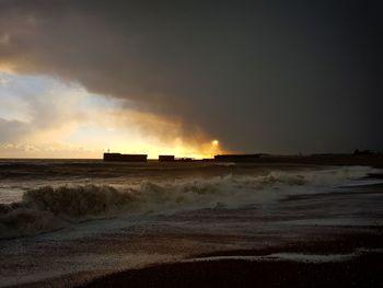 Scenic view of beach against sky during sunset