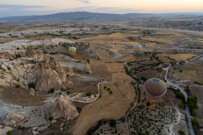 Wide angle panoramic view with hot air balloons flying over cappadocia, central anatolia, turkey