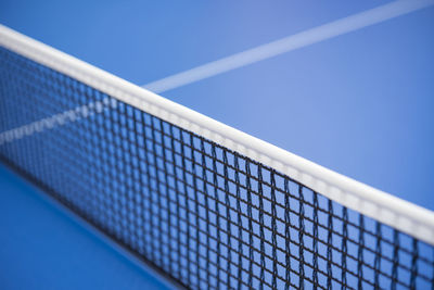 Close-up of a net against clear blue sky