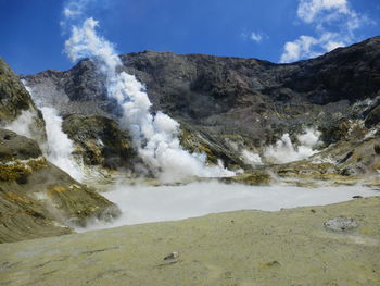Scenic view of waterfall against sky