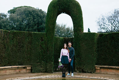 Full length of couple in formal garden