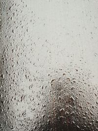 Full frame shot of raindrops on beach