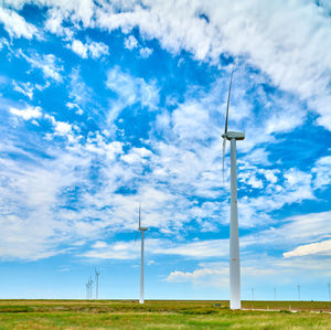 Windmill on field against sky