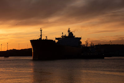 Profile of a tanker ship at sunset
