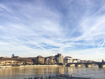 Bridge over river against buildings in city