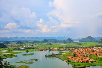 Scenic view of lake and mountains against sky