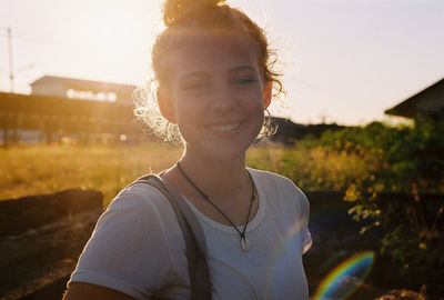 Portrait of young woman standing outdoors