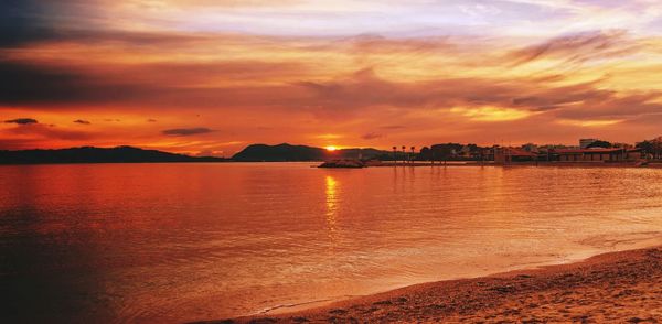 Scenic view of sea against orange sky