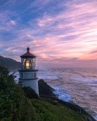Lighthouse at seaside during sunset