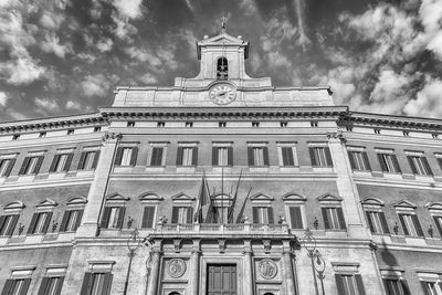 Low angle view of building against cloudy sky