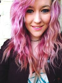 Close-up portrait of smiling young woman