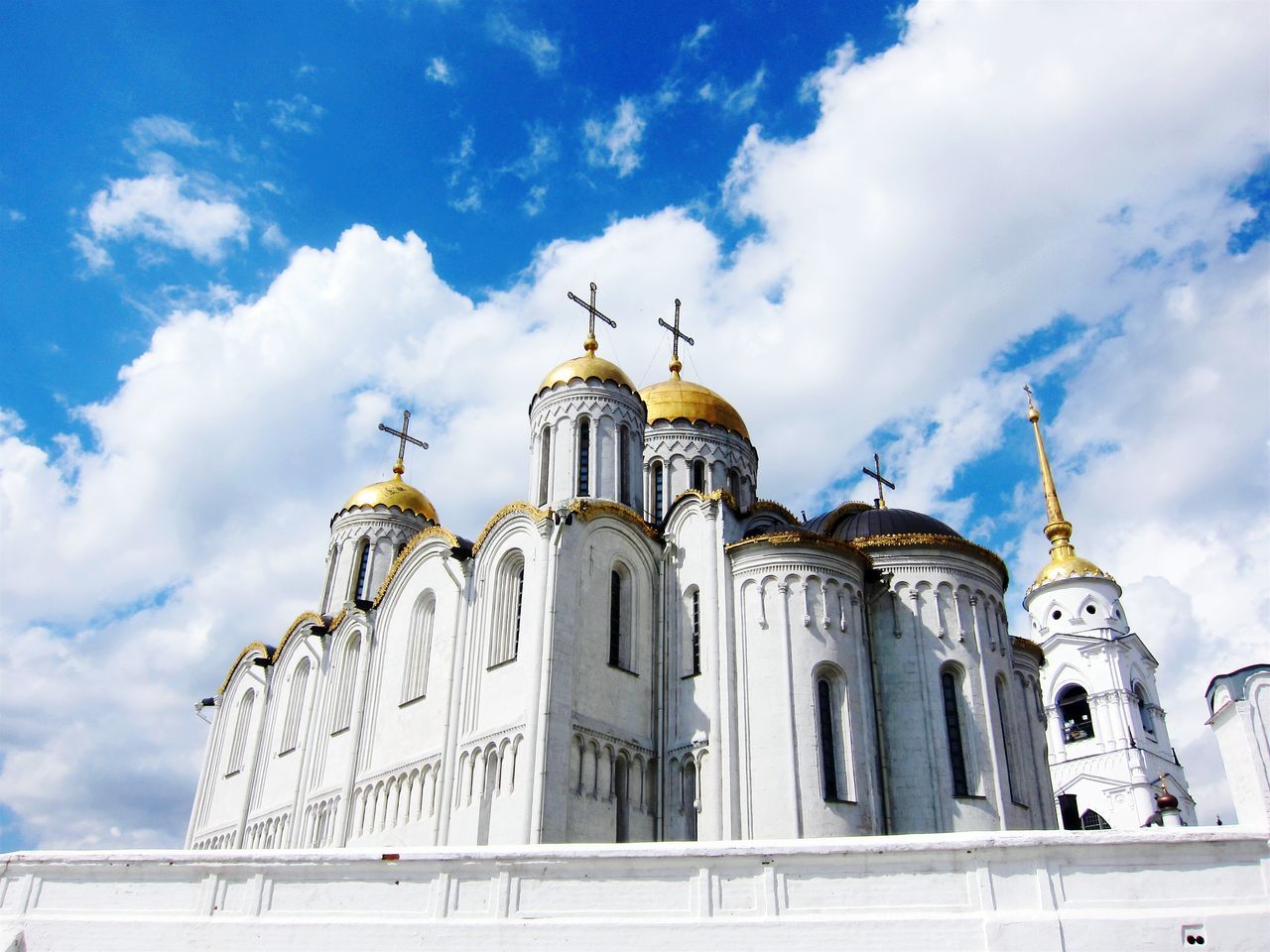 place of worship, religion, church, architecture, building exterior, spirituality, built structure, cathedral, sky, low angle view, dome, cross, cloud - sky, travel destinations, cloud, facade, famous place, blue