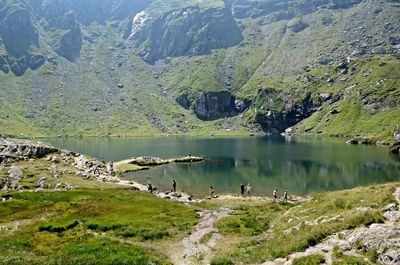 Scenic view of lake by mountain against sky